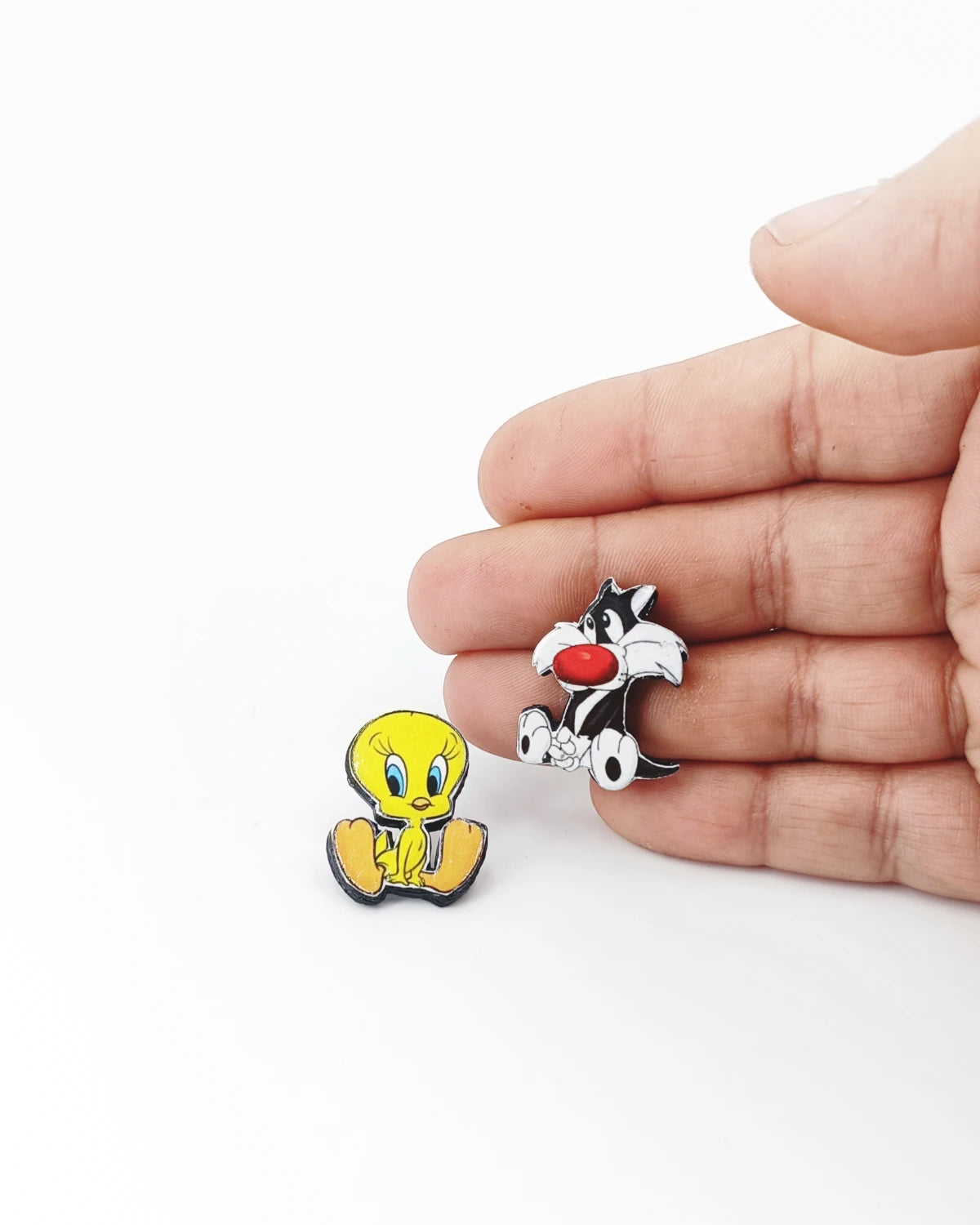 Orecchini a lobo Titti e gatto Silvestro su mano